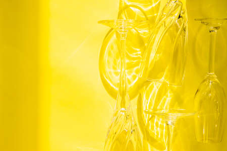 Empty glasses stand on a yellow background, top view.の写真素材