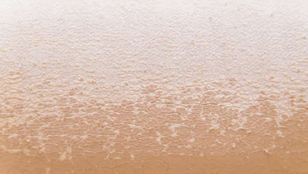 The texture of cracked skin. Old beige leather. Upholstery.Scuffed the surface of the leather...