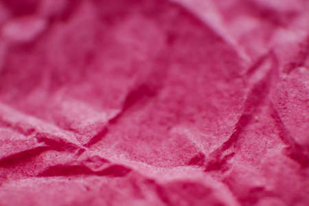 Crumpled pink paper. Macro photography of paper. Texture and background. Gift wrapping paper.の写真素材