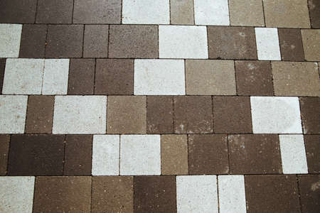 Background of stones on the sidewalk. The shape of square bricks on the road. The texture of the...
