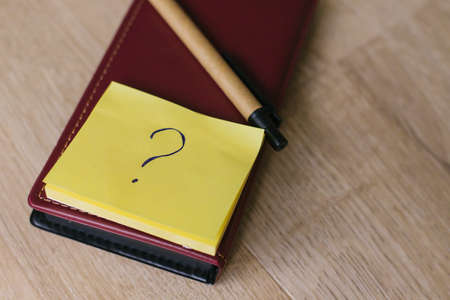 Stickers in the form of a yellow square are placed on a leather notebook. Notebooks for notes and...