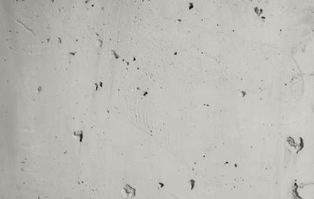 The texture of a concrete wall. Uneven and rough surface of gray color.の写真素材