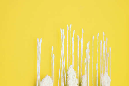 The fringe is white on a yellow background close-up. The interior is finished by hand. Texture of threads and textiles.の写真素材