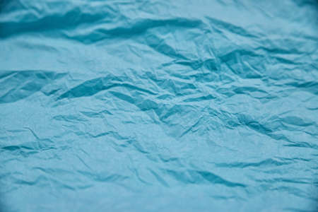 The texture of crumpled blue paper. Paper for wrapping gifts and flowers. Abstract background made of tissue paper.の写真素材
