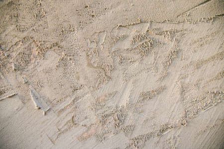 The texture of a gray concrete wall.Background of rough smears of cement on the wall.Abstract uneven surface.の写真素材