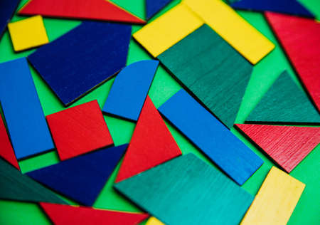 Abstract background. Texture with various colorful shapes of wooden blocks. Geometric shapes in different colors on a green background. The concept of creative, logical thinking or problem solving.の写真素材