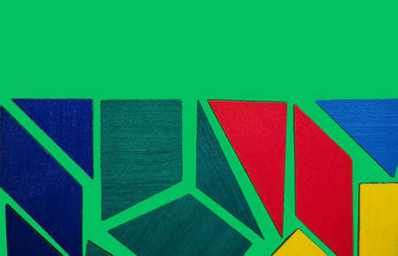 Abstract background. Texture with various colorful shapes of wooden blocks. Geometric shapes in different colors on a green background. The concept of creative, logical thinking or problem solving.の写真素材
