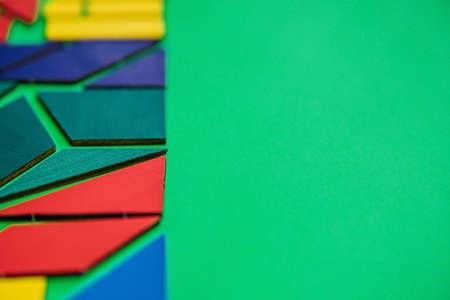 Abstract background. Texture with various colorful shapes of wooden blocks. Geometric shapes in different colors on a green background. The concept of creative, logical thinking or problem solving.の写真素材