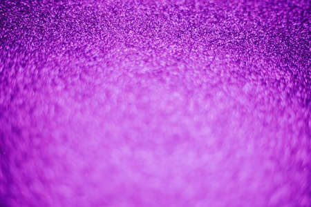 A blurry shimmering background of violet-colored sequins. Silver glitter, light abstract bokeh texture. Drawing design. Sparkling wallpaper for Christmas. Party time.の写真素材