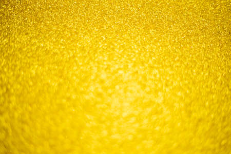 Blurry shimmering background of gold-colored sequins. Silver glitter, light abstract bokeh texture. Drawing design. Sparkling wallpaper for Christmas. Party time.の写真素材