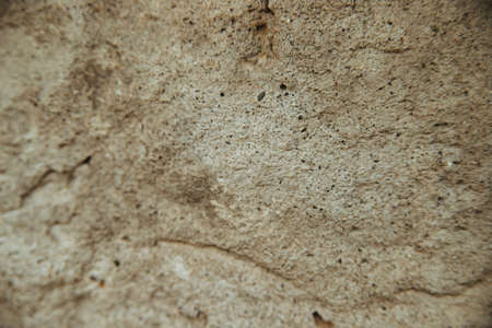 A concrete ruined wall. A surface with large cracks. Cement texture. Background.