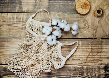 Zero waste concept, reusable mesh shopping bags.Eco-bag made of natural cotton fabric on a wooden background. A sustainable lifestyle.Top view.の写真素材