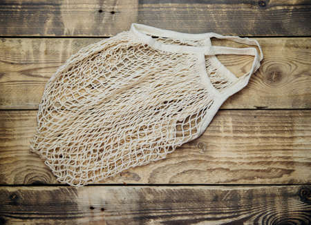 Zero waste concept, reusable mesh shopping bags.Eco-bag made of natural cotton fabric on a wooden...