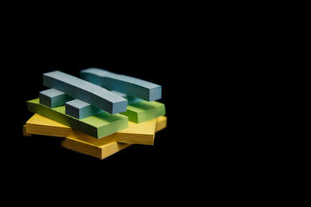 A stack of colorful stickers on a black background. Narrow stickers for records. Office supplies.の写真素材