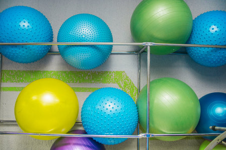 Sports equipment in the fitness center or gym. Gym balls are on the shelf. The concept of a healthy and active lifestyle.の写真素材
