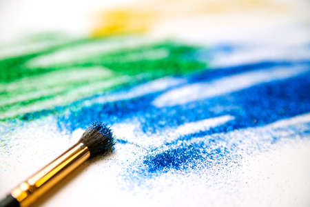 Abstract texture of small sequins. Brilliant festive background. Multicolored sequins and a tassel on a white background.の写真素材