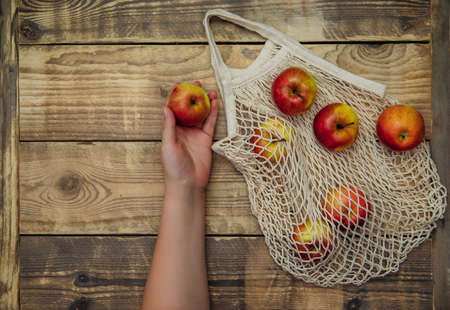 Zero waste concept, reusable mesh shopping bags.Eco-bag made of natural cotton fabric on a wooden...