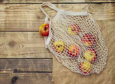 Zero waste concept, reusable mesh shopping bags.Eco-bag made of natural cotton fabric on a wooden...