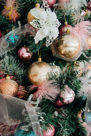 Branches of a Christmas tree decorated with toys for the new year. Christmas balls and garland....