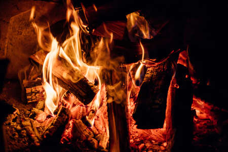 Fire flames on black background.Natural fuel and energy. The fire in the natural forest, flames and sparks on a dark background.の写真素材