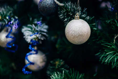 Branches of a Christmas tree decorated with toys for the new year. Christmas balls and garland. Christmas background.の写真素材