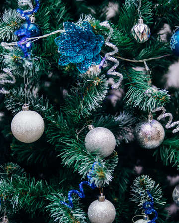 Branches of a Christmas tree decorated with toys for the new year. Christmas balls and garland. Christmas background.の写真素材