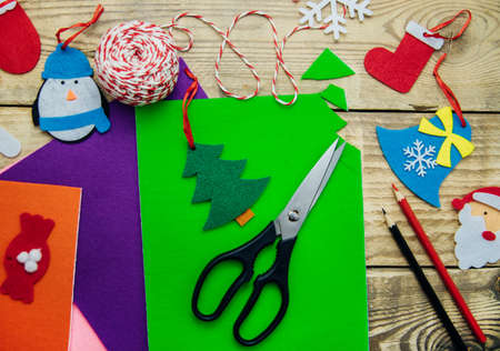 Making handmade Christmas toys from felt with your own hands. Decorations for the Christmas tree or home interior. Step 2. Cut the toy along the contour.の写真素材