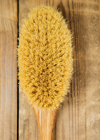 Wooden brush for dry body massage. Anti-cellulite brush for body and leg massage on a wooden...