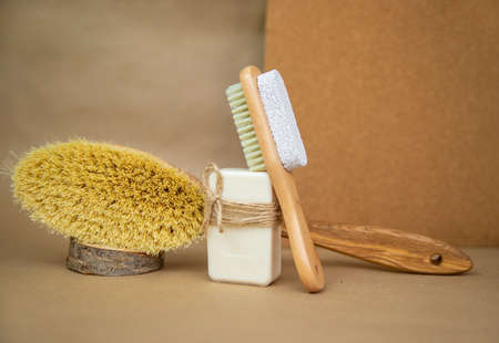 Wooden brush for dry body massage and natural soap. Foot brush and pumice stone for heels on beige...