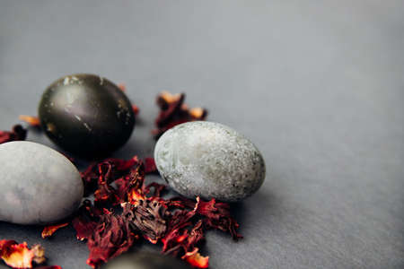 Painted Easter eggs with the effect of marble stone, painted with natural hibiscus tea karkade. A postcard for the celebration of Easter. Texture and festive background.の写真素材