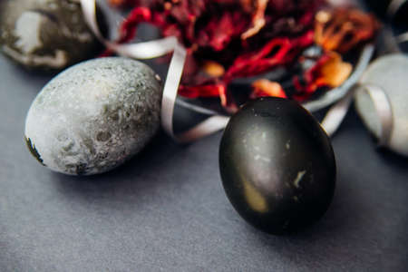 Painted Easter eggs with the effect of marble stone, painted with natural hibiscus tea karkade. A postcard for the celebration of Easter. Texture and festive background.の写真素材