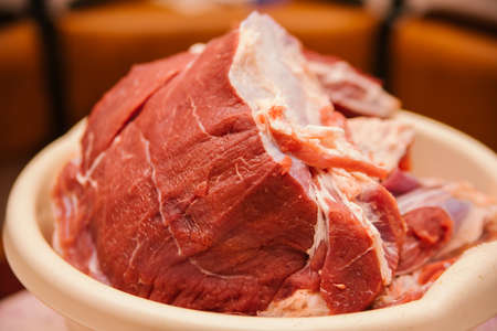 A large piece of raw meat cut into the shape of a square. fresh beef. Preparation for cooking. dietary meat.の写真素材