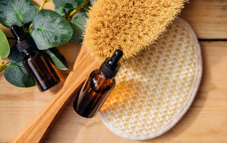 The concept of spa treatment. Natural, organic cosmetics with eucalyptus oil, massage brush,...