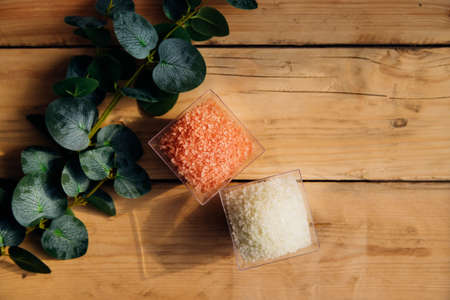 Alternative medicine.Cosmetic sea salt close-up. salt crystals. Skin care products and spa cosmetics on a wooden table.の写真素材