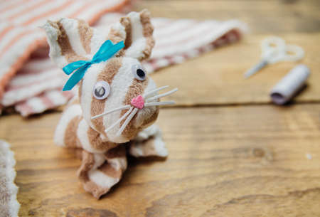 How to make an Easter Bunny. Materials for toys towel, scissors, thread. DIY concept. Step by step photo instructions. Step 6. Ready-made bunny from a towel.の写真素材