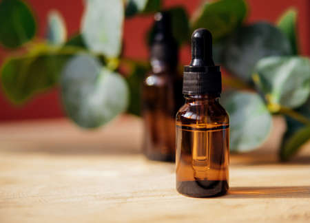 Alternative medicine.A bottle of natural organic cosmetics with oil. Aromatherapy and massage. Skin care products and spa cosmetics on a wooden table.の写真素材
