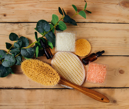 The concept of spa treatment. Natural, organic cosmetics with eucalyptus oil, sea salt, massage brush, eucalyptus leaf extract. spa background. alternative medicine.の写真素材