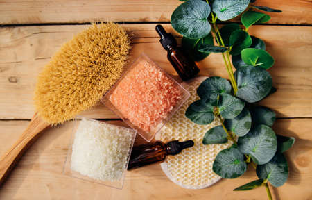 The concept of spa treatment. Natural, organic cosmetics with eucalyptus oil, sea salt, massage brush, eucalyptus leaf extract. spa background. alternative medicine.の写真素材