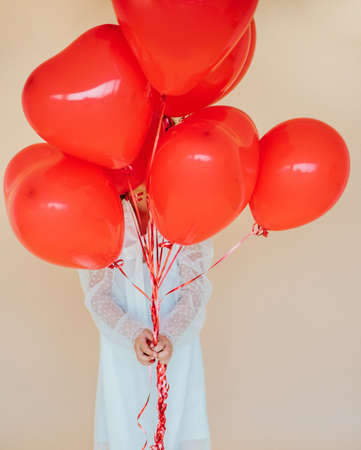 Cute little girl with heart shaped balloons on Valentine's day. family, love. gifts for the holiday....