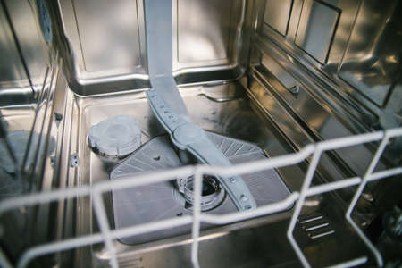 Dishwasher close-up. Modern built-in kitchen appliances. device, and details. Filter for dishwashers.の写真素材