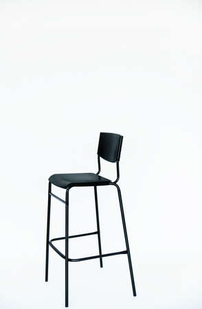 Black high bar stool, on a white background. A modern model. Comfortable furniture for a bar or restaurant.の写真素材