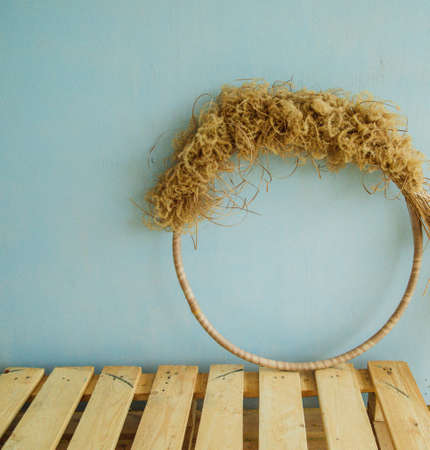 Decorative circle of dry grass and reeds. Decoration for the interior of the room.の写真素材