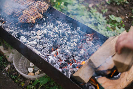Fresh meat for barbecue, fried on fire. selective focus. Grilled lamb meat. Cooking barbecue on the grill with smoke. Picnic in nature. Healthy food and proper nutrition.の写真素材