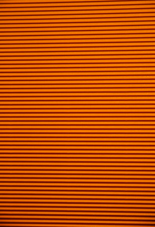 Abstract background made of corrugated paper for orange application. Space for text. texture. horizontal stripes.の写真素材