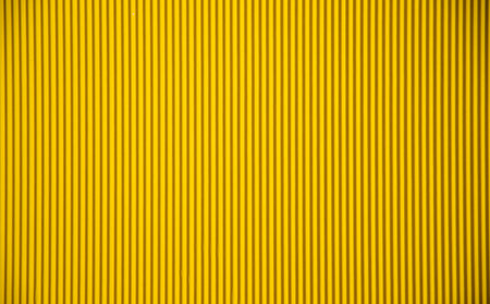 Abstract background made of corrugated paper for yellow application. Space for text. texture....