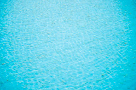Abstract background and texture. Ripples on clear water. Ceramic blue tile. Cleaning the pool.の写真素材