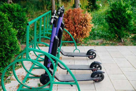 Electric scooter in the parking lot in the park. city electric scooter. The concept of electric urban transport. Eco-friendly trip around the city or park. Active leisure.の写真素材
