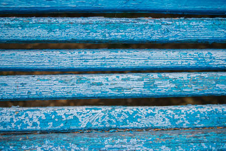 Wooden boards painted in blue. Rough and cracked surface. Old wood and paint. Background and...
