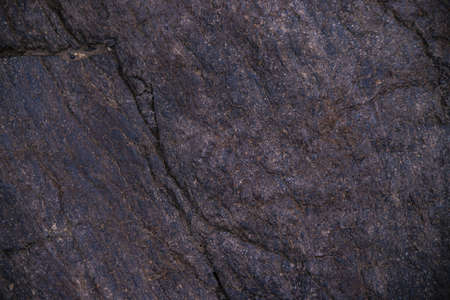 Stone black textured background. natural stone. The black background is a blank for the design. Uneven surface.の写真素材