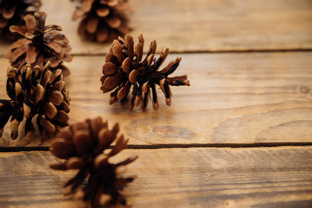 Background with pine cones on a dark wooden board. Christmas, New Year's composition with a place to...